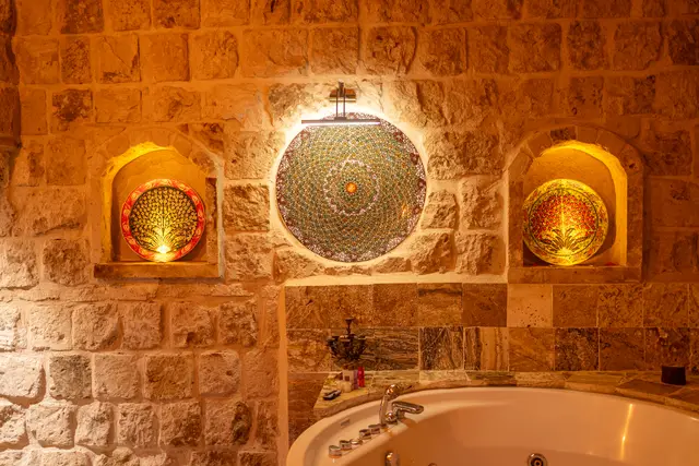 An arched alcove in an ornately styled hotel room.