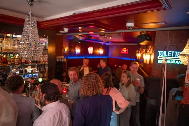 A busy crowd filling an event venue.